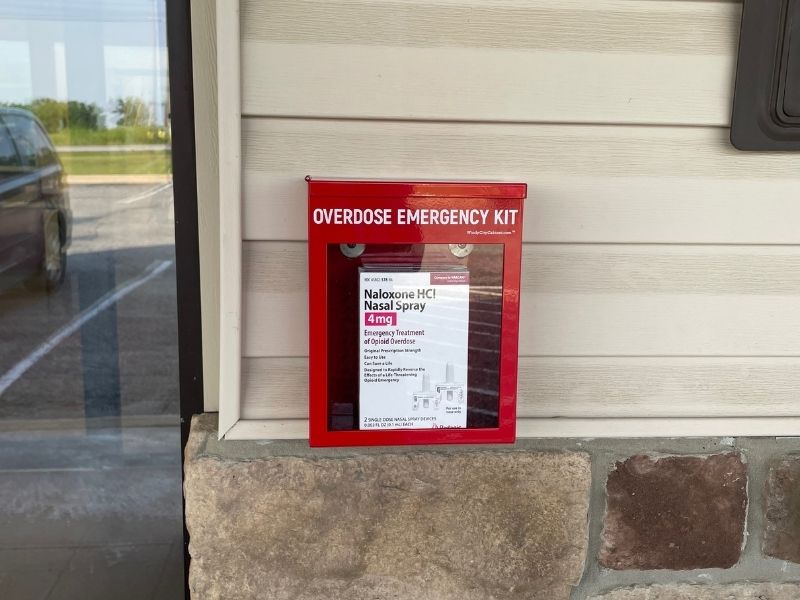 Overdose emergency kit box hanging on the exterior wall of the Taney County Health Department.