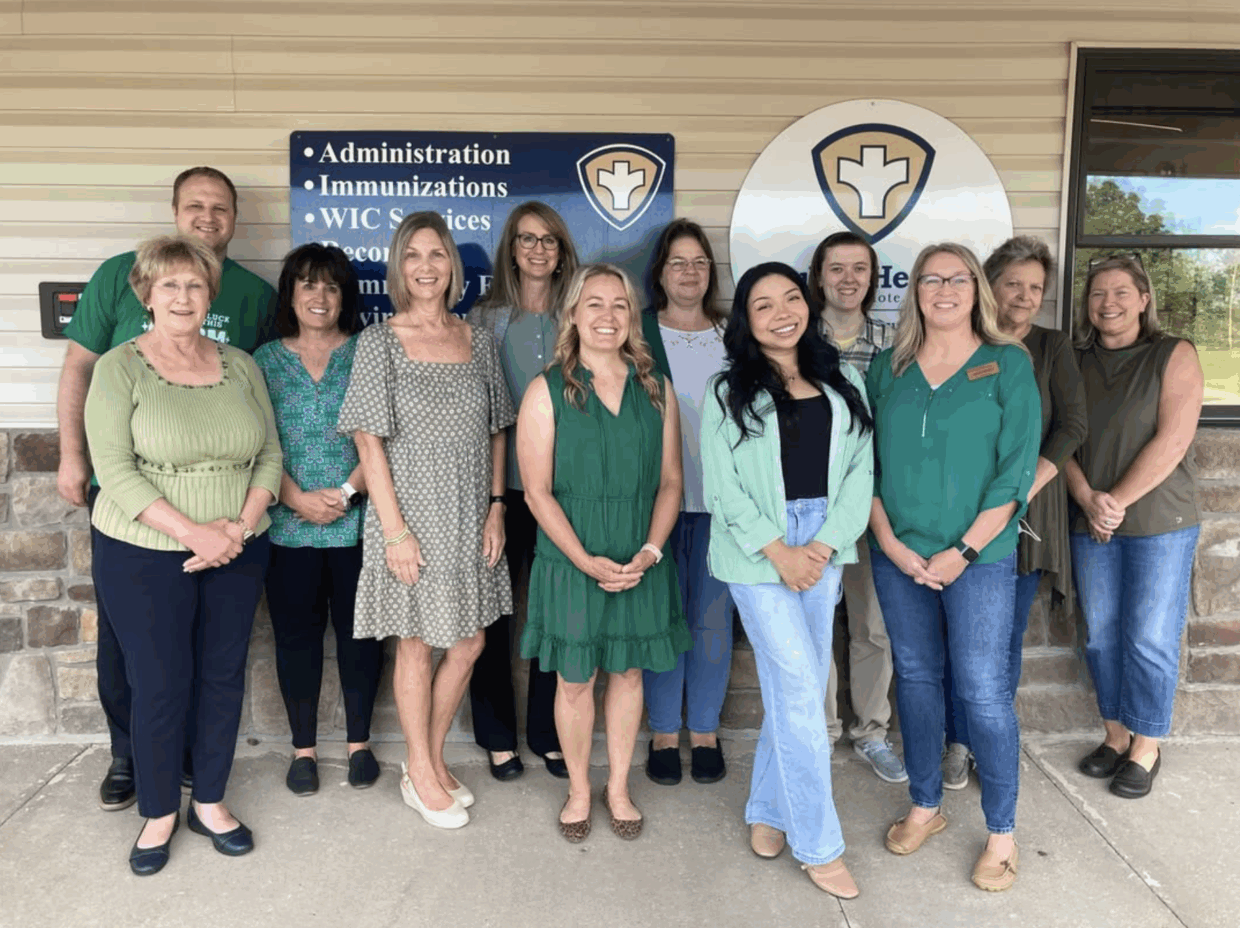 TCHD staff all dressed in green in front of Branson office
