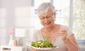 older adult eating salad