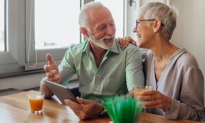 older adult couple using a tablet