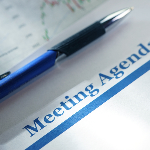 meeting agenda with pen laying on top