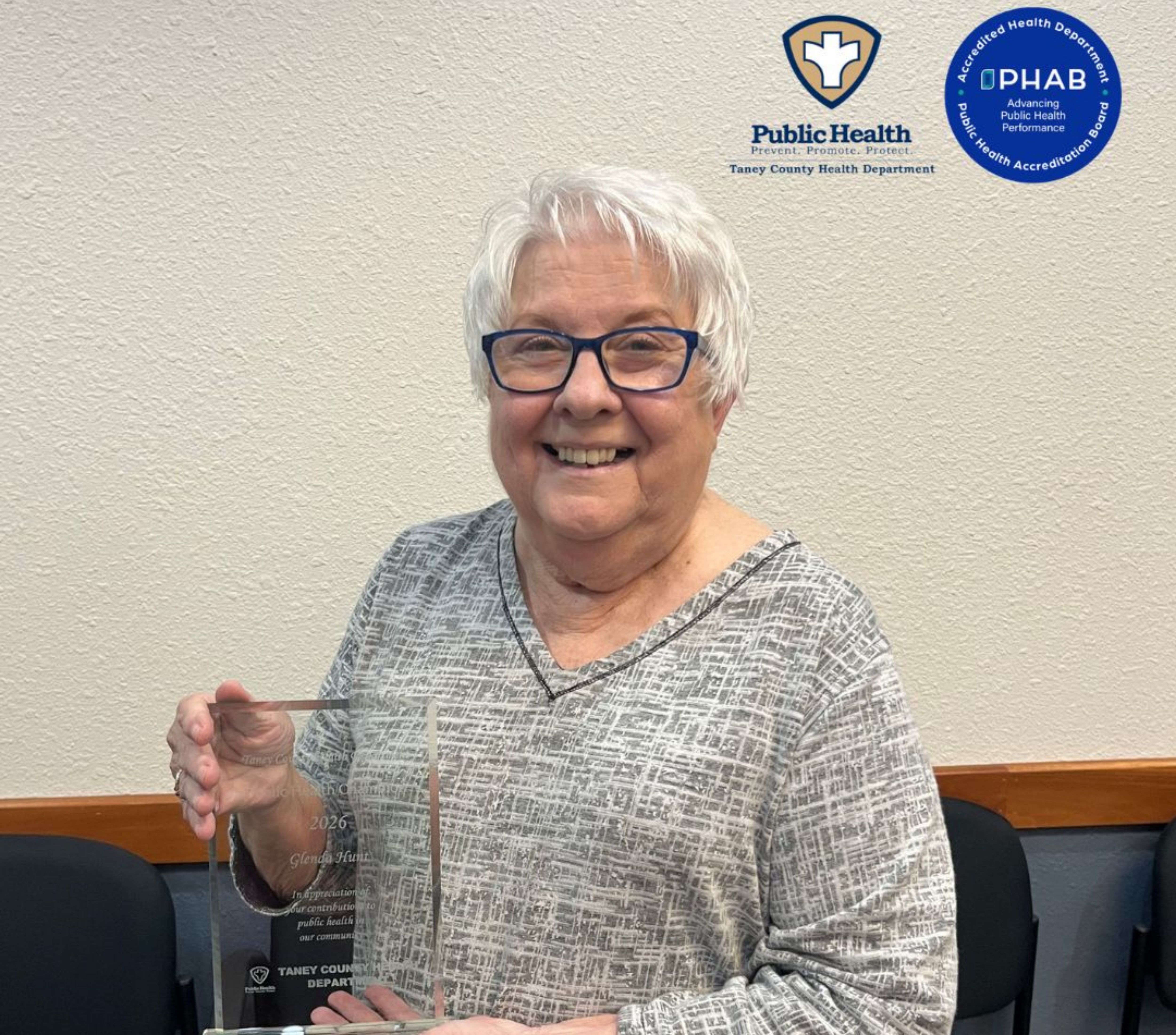 Picture of Glenda Hunt holding the 2026 Public Health Champion award.
