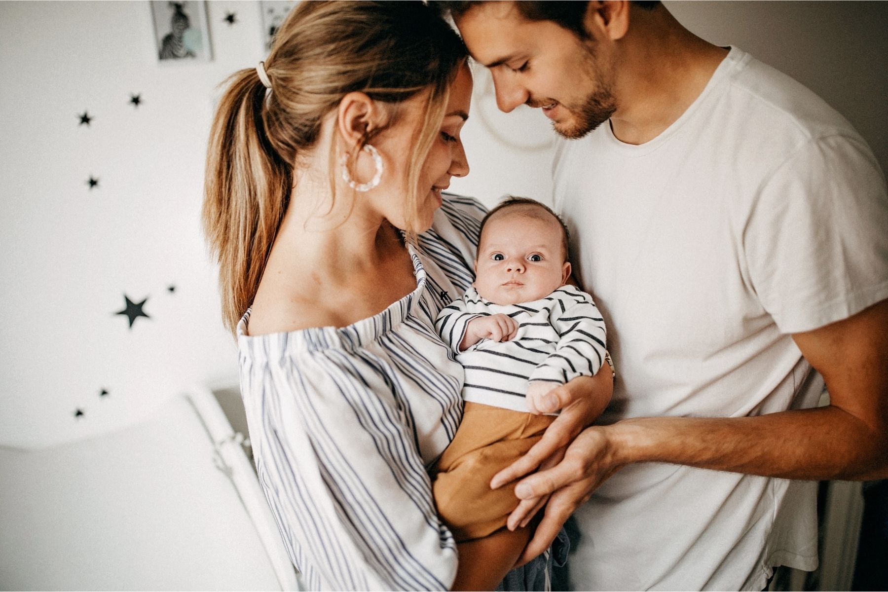 Mom and dad holding a new baby.